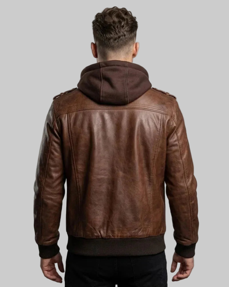 Man wearing a brown leather jacket with a hood on a gray background