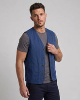 Men's royal blue cotton utility vest with front patch pockets and tailored fit, shown in front, side, and back view