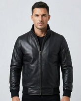 Man wearing a black leather jacket against a light gray background