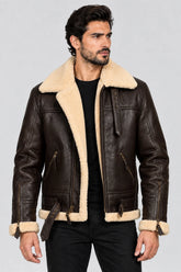 Men’s dark brown B3 aviator leather jacket with a cream shearling collar, buckle straps and zippered waist pockets.