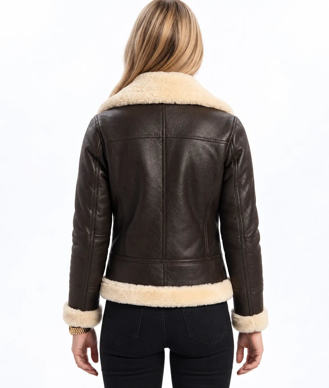 A woman shown from the back wearing a dark brown faux-leather shearling jacket with a cream-colored collar and hem, paired with black pants, against a plain white background.