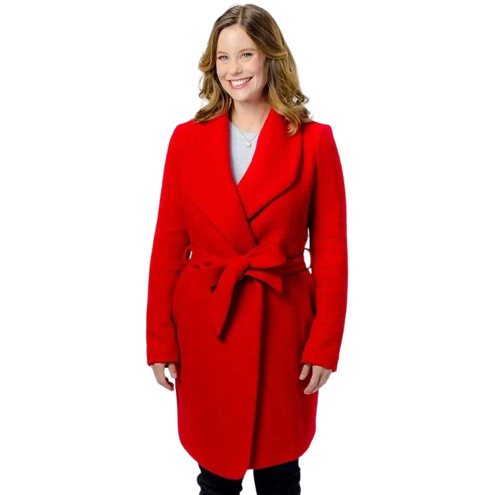 Woman wearing a red coat on a white background