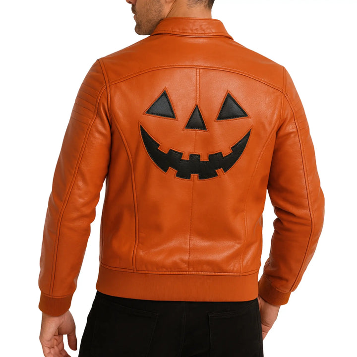 Orange leather jacket with a jack-o'-lantern face design on the back, worn by a person.