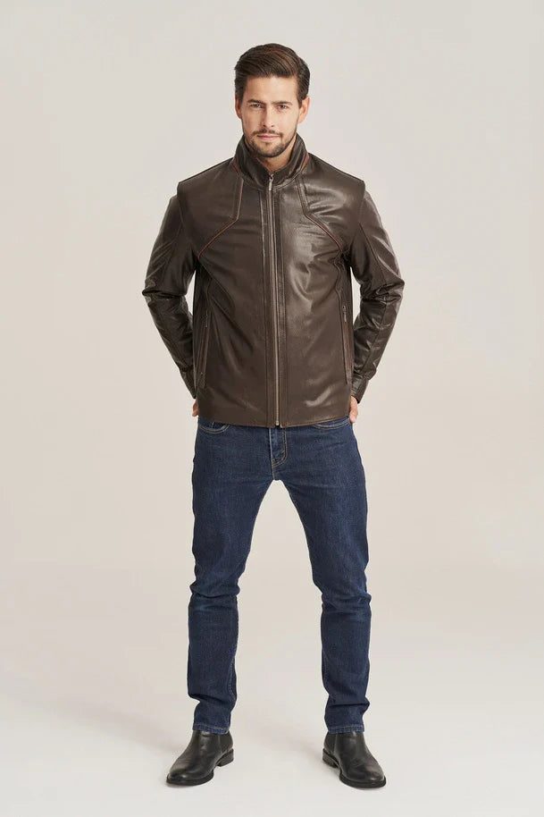 Man wearing a brown leather jacket and blue jeans on a white background