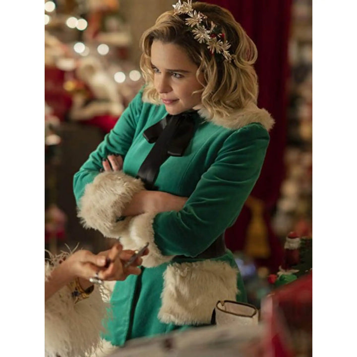Woman in a festive outfit holding a teddy bear with blurred Christmas decorations in the background