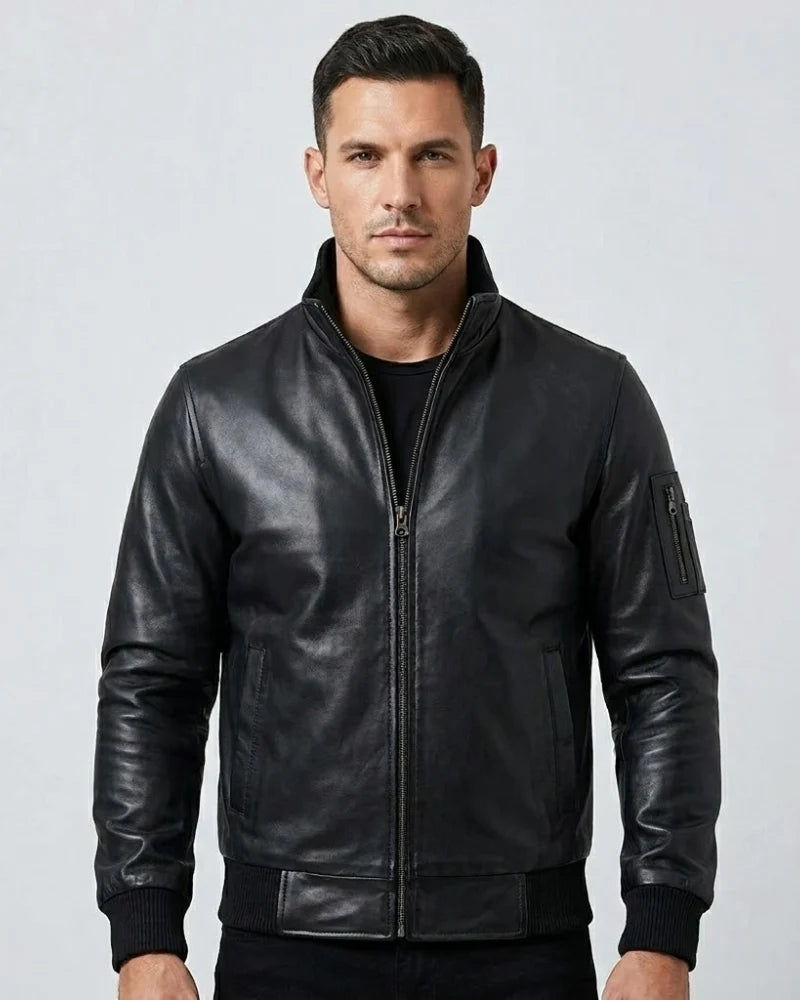 Man wearing a black leather jacket against a light gray background