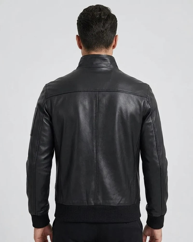 Man wearing a black leather jacket on a light gray background