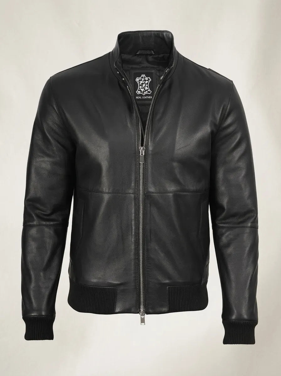 black leather bomber jacket over a white T-shirt, showing the stand-up collar, front zipper and ribbed cuffs.