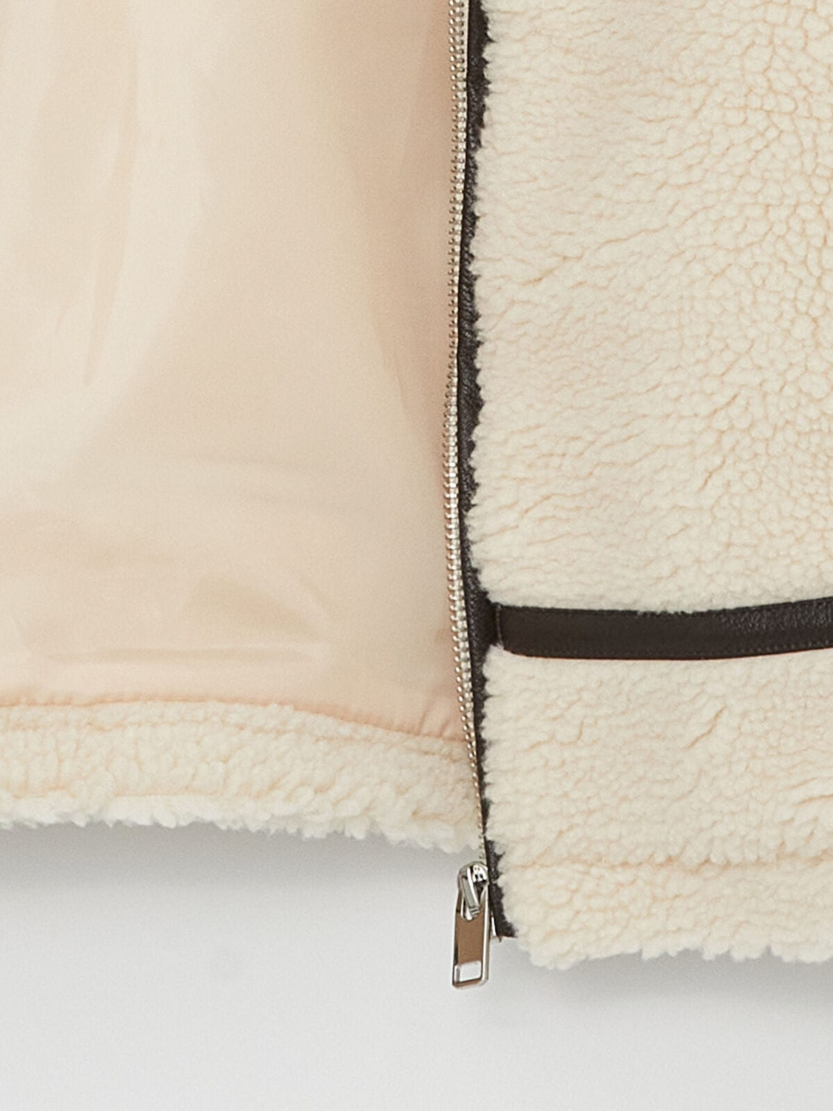Close-up of a beige fleece jacket with a zipper on a white background